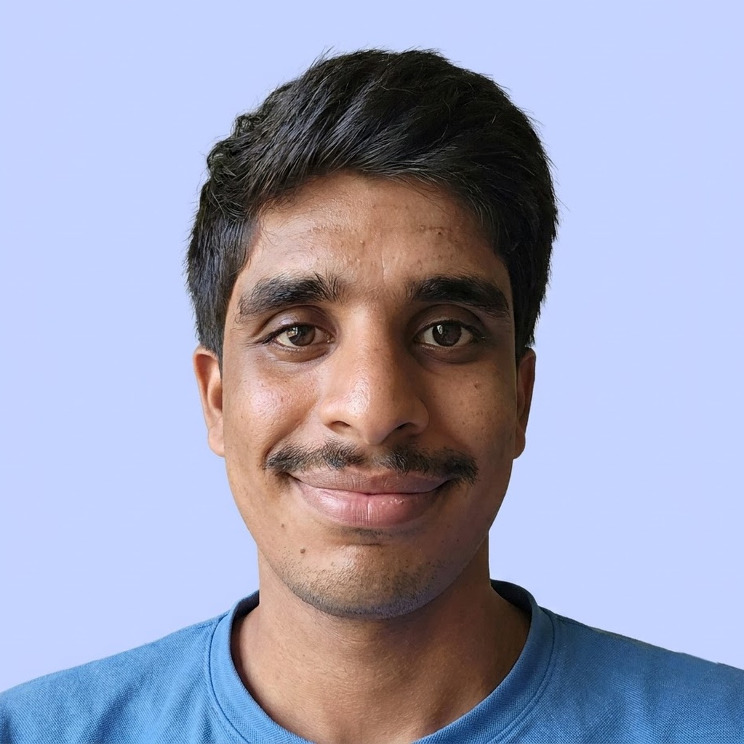 Charan, smiling, in a blue t-shirt